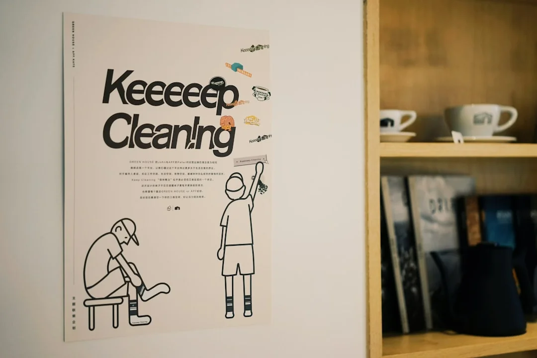 A tidy home office space featuring a wooden desk, chair, broom, and cleaning equipment.
